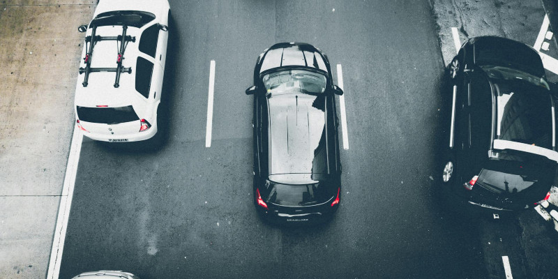 Cars journey along a road.